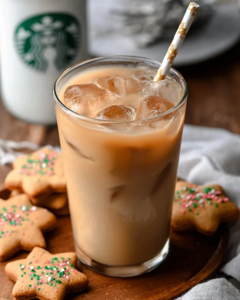 Iced sugar cookie almond milk latte in a glass with festive decor