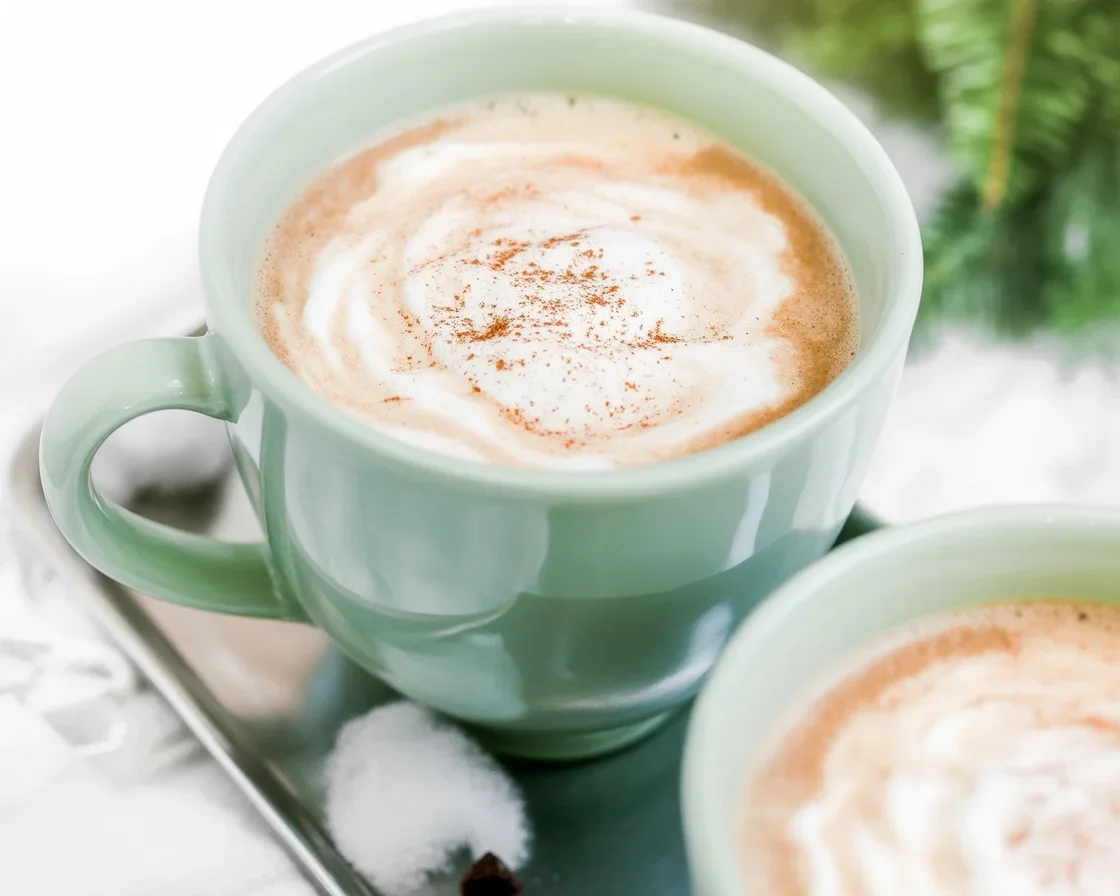 Creamy Eggnog Latte topped with whipped cream and nutmeg for a festive flavor.