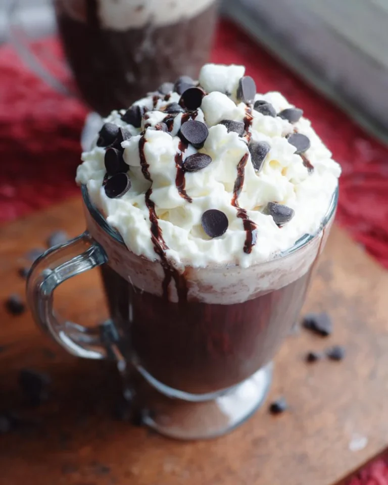 Boozy Zebra Hot Chocolate topped with whipped cream and chocolate drizzle