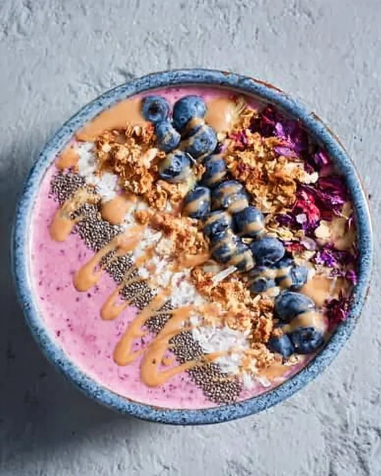 Berry, coconut, and chia smoothie bowl topped with fresh fruits and seeds.