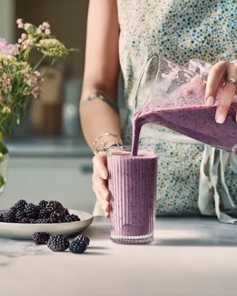 Delicious blackberry breakfast smoothie in a glass with fresh blackberries