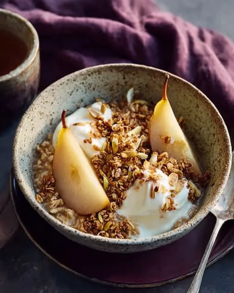 Overnight oats topped with cardamom-poached pears, peanut butter, and granola
