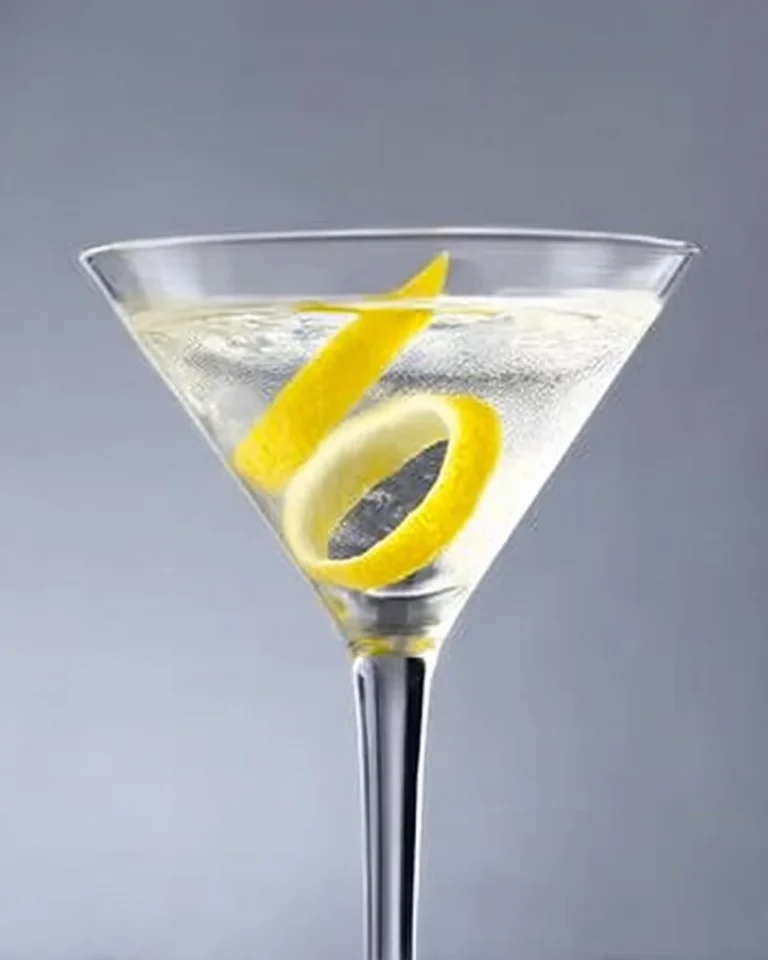 Vodka martini glass with olives on a stylish bar counter