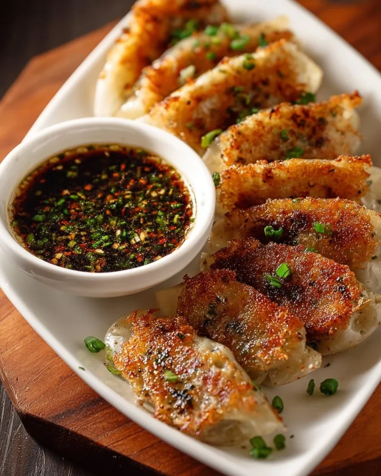 Crispy shrimp chicken dumplings on a plate, showcasing rice paper and colorful ingredients.