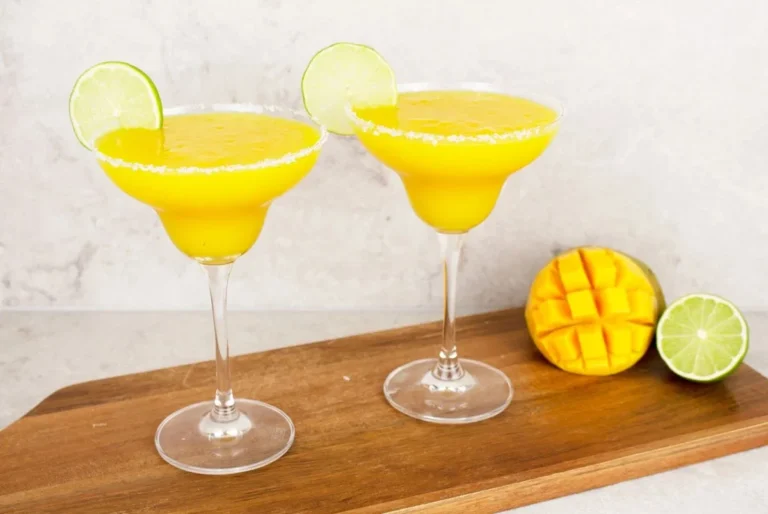 Delicious Virgin Mango Margarita in a glass garnished with fresh mango slices